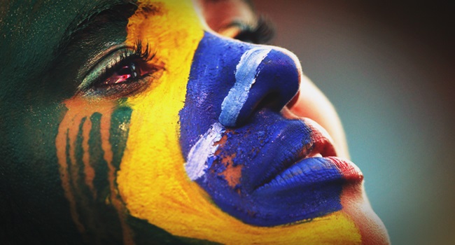 A Brazil fan cries as she watches the 2014 World Cup semi-final between Brazil and Germany at a fan area in Brasilia