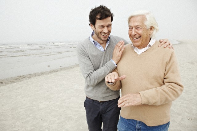 Father and adult son laughing and talking